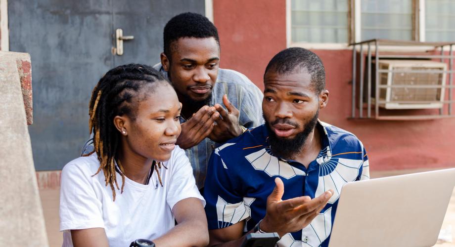Teachers and nurses using laptops to register on the NSA portal in Ghana